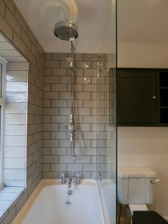 Bathroom with metro tiled shower over bath